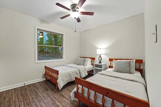 bedroom with dark wood finished floors, baseboards, and ceiling fan