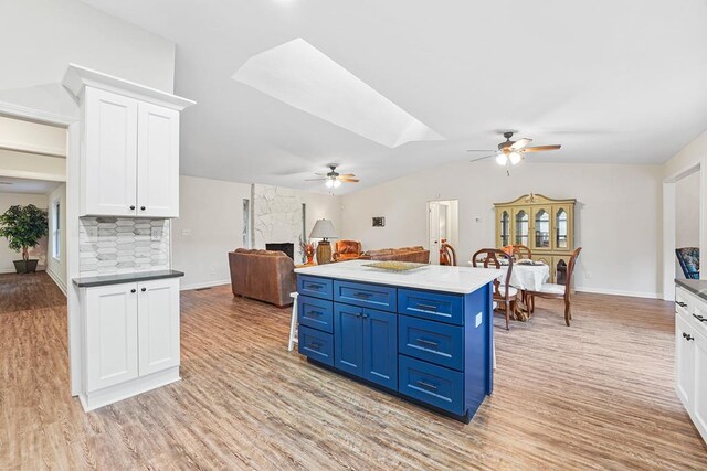 dining area with hardwood / wood-style floors, vaulted ceiling, and plenty of natural light