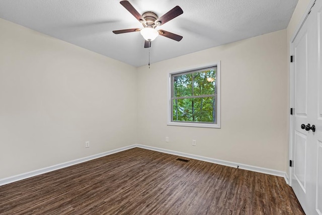 unfurnished room with ceiling fan and dark hardwood / wood-style flooring