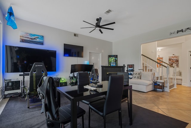 tiled dining area with ceiling fan