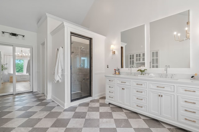 bathroom with an enclosed shower, vanity, a chandelier, and lofted ceiling