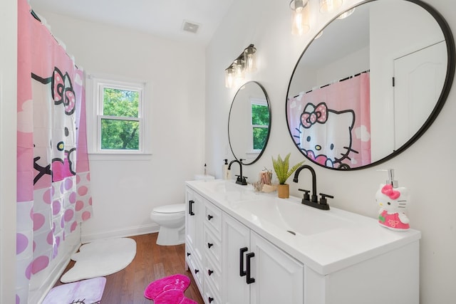 bathroom with vanity, hardwood / wood-style flooring, toilet, and curtained shower