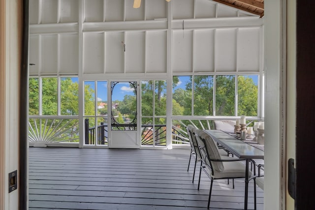 sunroom featuring ceiling fan and plenty of natural light