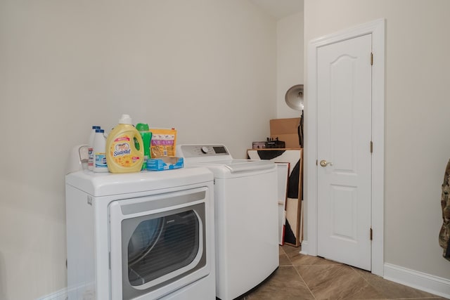 laundry area with washing machine and dryer and light tile patterned flooring