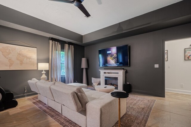 tiled living room featuring ceiling fan