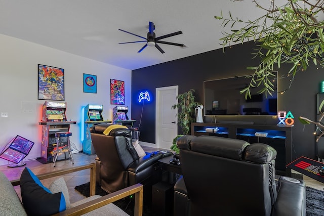 living room featuring ceiling fan and a textured ceiling