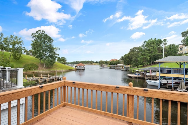 wooden terrace featuring a boat dock and a water view