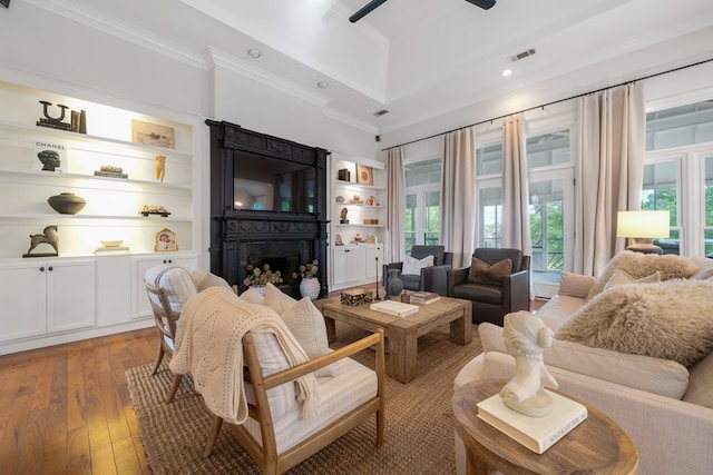 living room with ceiling fan, wood-type flooring, and crown molding