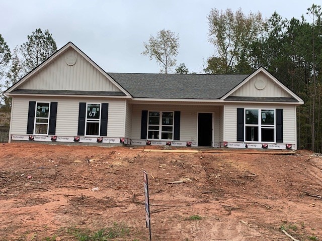465 Riley Cir, Milledgeville, GA 31061 - view of front of house featuring covered porch, board and batten siding, and roof with shingles