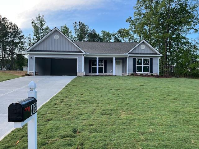 465 Riley Cir, Milledgeville, GA 31061 - ranch-style house featuring covered porch, driveway, an attached garage, a front yard, and board and batten siding