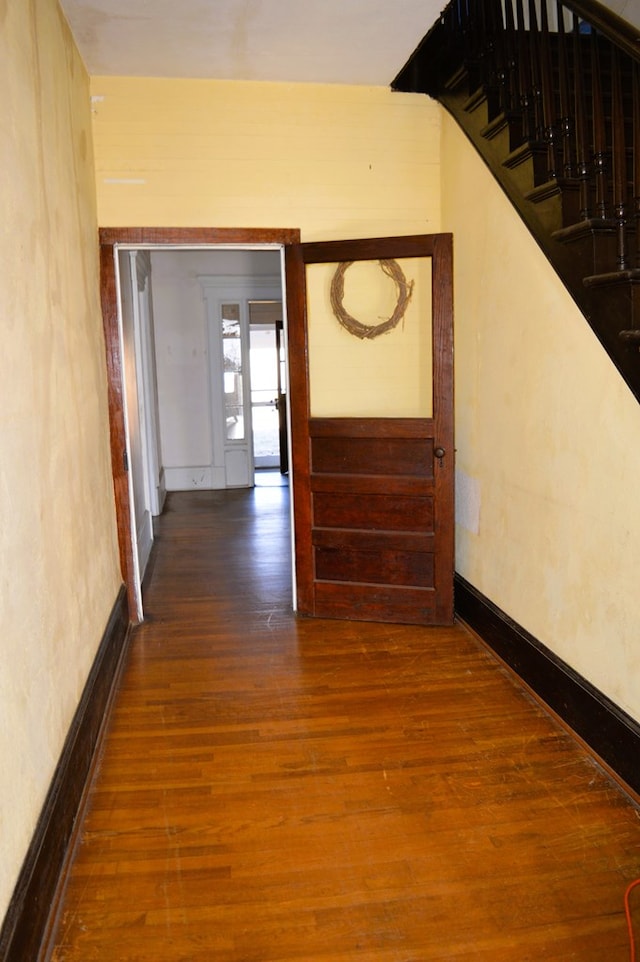 hallway with dark hardwood / wood-style floors