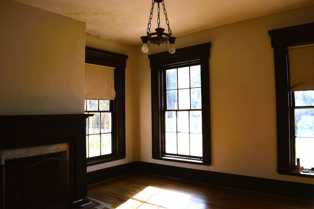 unfurnished living room featuring hardwood / wood-style floors and plenty of natural light