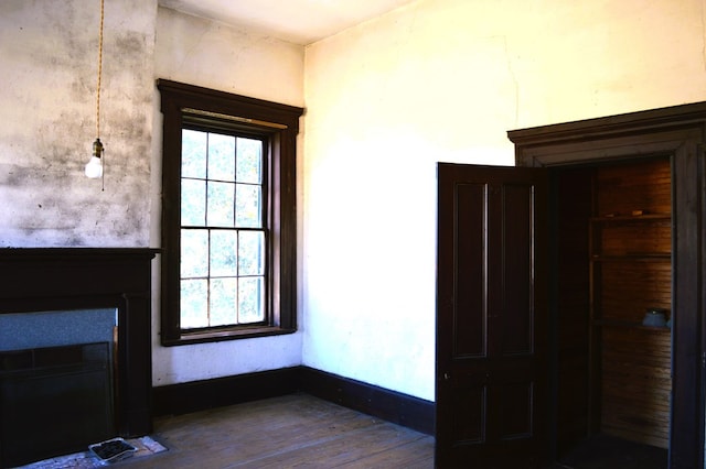 interior space with a wealth of natural light and hardwood / wood-style floors