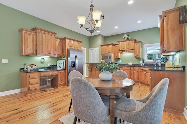 229 Old Plantation Trl, Milledgeville, GA 31061 - kitchen featuring dark countertops, appliances with stainless steel finishes, and a notable chandelier