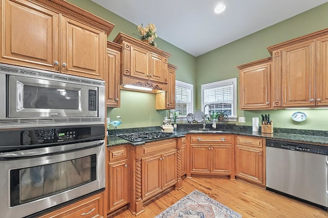 229 Old Plantation Trl, Milledgeville, GA 31061 - kitchen featuring light wood-style floors, a sink, dark stone countertops, and appliances with stainless steel finishes