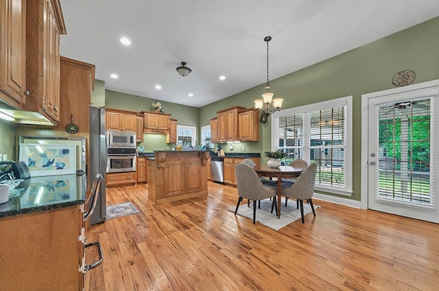 229 Old Plantation Trl, Milledgeville, GA 31061 - kitchen with appliances with stainless steel finishes, hanging light fixtures, a center island, light wood finished floors, and an inviting chandelier