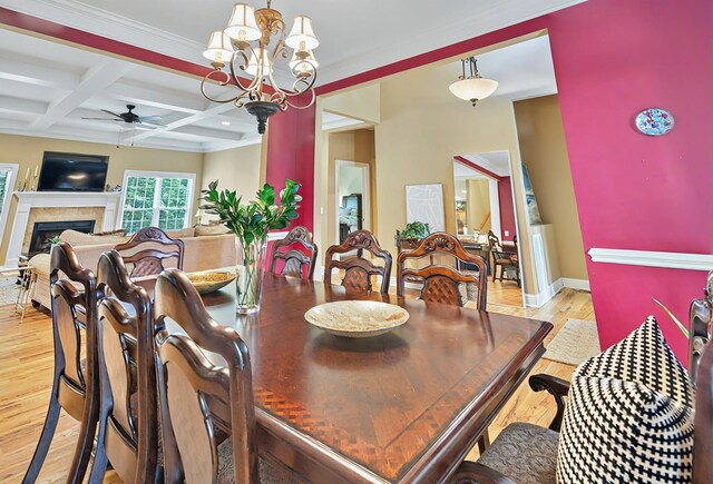 229 Old Plantation Trl, Milledgeville, GA 31061 - dining area featuring beam ceiling, light wood finished floors, a fireplace, ceiling fan with notable chandelier, and baseboards