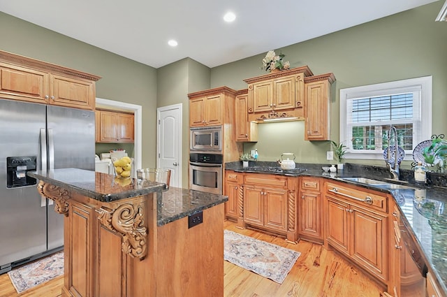 229 Old Plantation Trl, Milledgeville, GA 31061 - kitchen with washer and clothes dryer, a sink, appliances with stainless steel finishes, and light wood-style flooring