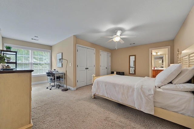 229 Old Plantation Trl, Milledgeville, GA 31061 - carpeted bedroom featuring visible vents, two closets, baseboards, ensuite bathroom, and ceiling fan