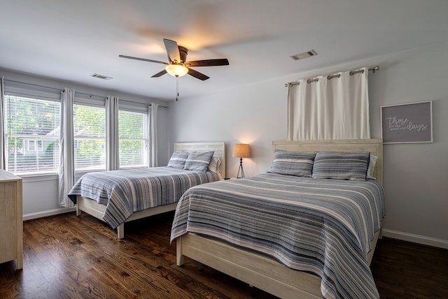 bedroom with baseboards, wood finished floors, and a ceiling fan