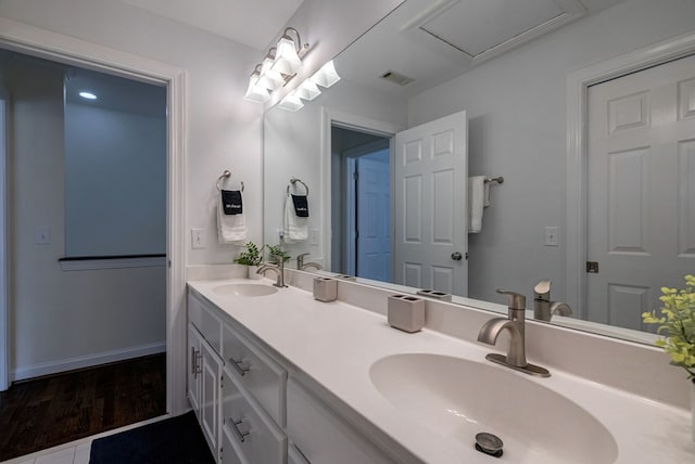 bathroom featuring wood finished floors and double vanity