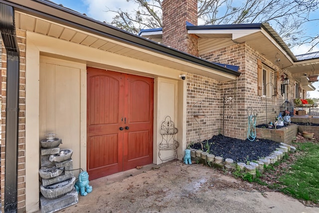100 Cross Plains Hulett Rd, Carrollton, GA 30016 - property entrance with brick siding, a garage, and a chimney