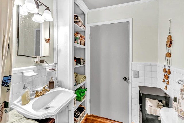 100 Cross Plains Hulett Rd, Carrollton, GA 30016 - bathroom with tile walls, a sink, crown molding, and wainscoting