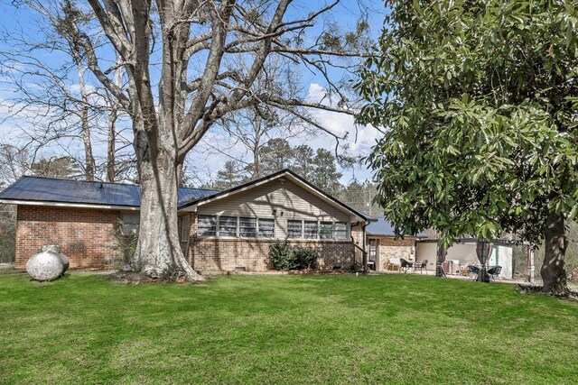 100 Cross Plains Hulett Rd, Carrollton, GA 30016 - exterior space with a patio, brick siding, and a yard