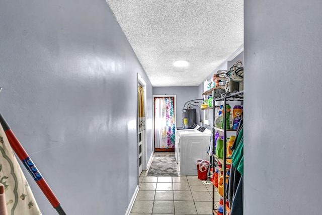 100 Cross Plains Hulett Rd, Carrollton, GA 30016 - laundry area with light tile patterned flooring, a textured ceiling, independent washer and dryer, laundry area, and water heater