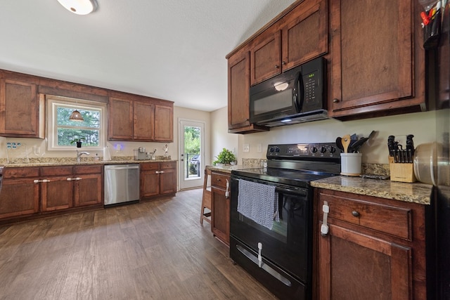 167 NW Old Plantation Trl, Milledgeville, GA 31061 - kitchen featuring black appliances, dark wood finished floors, plenty of natural light, and light stone countertops