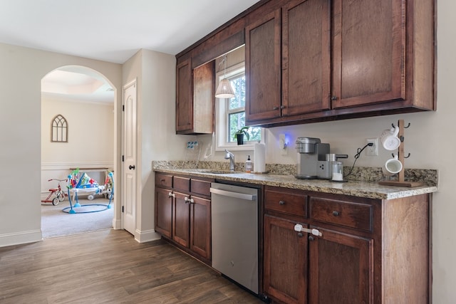 167 NW Old Plantation Trl, Milledgeville, GA 31061 - kitchen with dishwasher, dark wood-type flooring, arched walkways, light stone countertops, and dark brown cabinetry