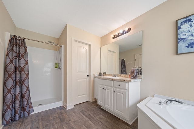 167 NW Old Plantation Trl, Milledgeville, GA 31061 - full bathroom featuring vanity, wood finished floors, curtained shower, and a bath