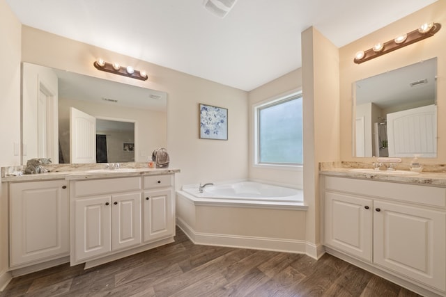 167 NW Old Plantation Trl, Milledgeville, GA 31061 - full bath with two vanities, wood finished floors, and a bath