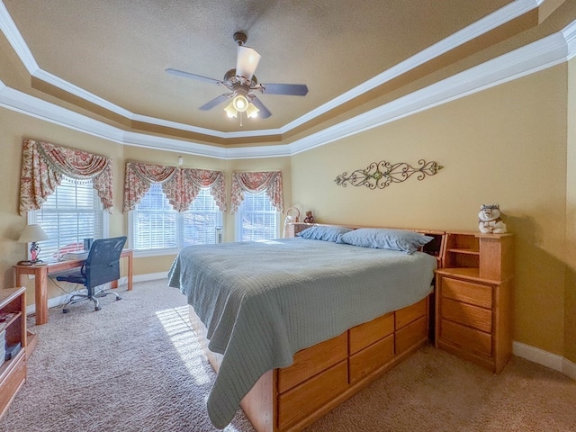 bedroom with crown molding, a raised ceiling, and carpet floors