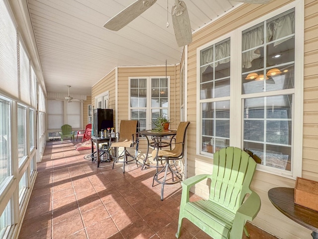 sunroom / solarium with wood ceiling and ceiling fan