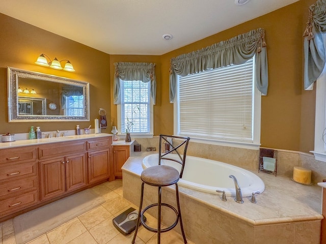 bathroom featuring vanity, tiled tub, and tile patterned floors