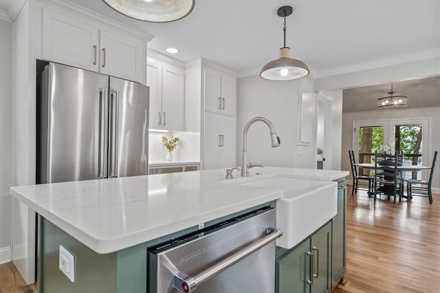 291 Power Point Rd, Milledgeville, GA 31061 - kitchen with stainless steel appliances, a sink, light wood finished floors, decorative light fixtures, and light stone countertops