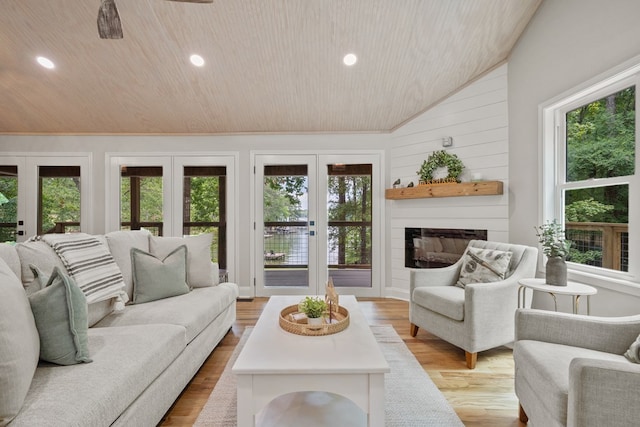 living room with wood ceiling, a large fireplace, french doors, vaulted ceiling, and light hardwood / wood-style flooring