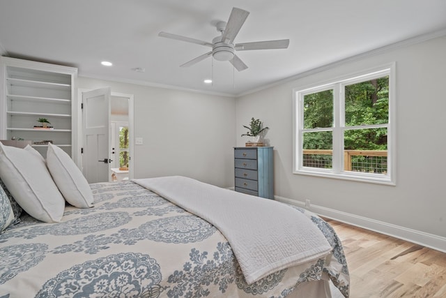 bedroom with ceiling fan, ornamental molding, and light hardwood / wood-style flooring