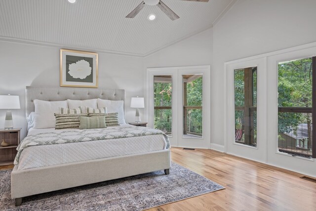 bedroom with ceiling fan, access to exterior, hardwood / wood-style floors, crown molding, and french doors