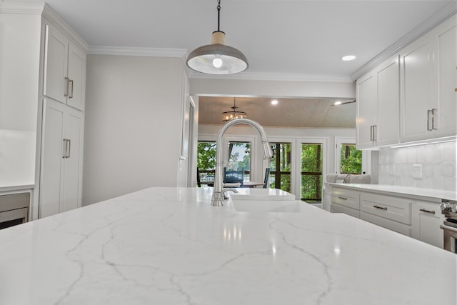 291 Power Point Rd, Milledgeville, GA 31061 - kitchen featuring white cabinetry, recessed lighting, tasteful backsplash, crown molding, and light stone countertops