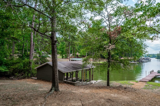 view of side of home with a water view and a boat dock