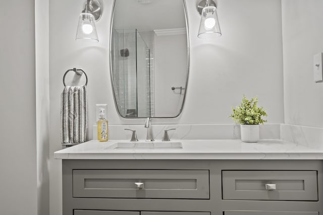 bathroom featuring vanity, a shower with door, and crown molding