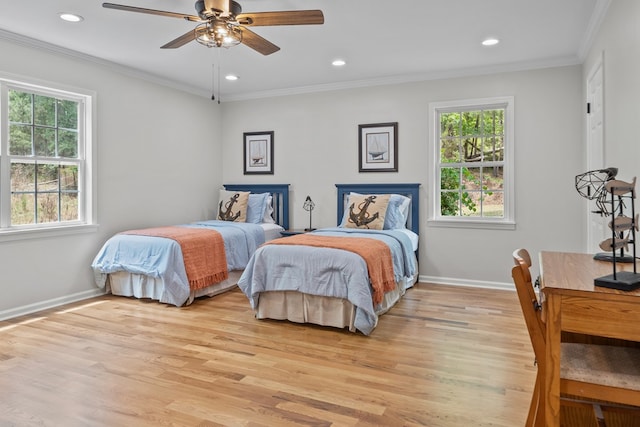 bedroom featuring ceiling fan, ornamental molding, and light hardwood / wood-style flooring