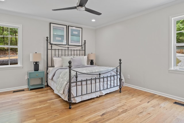 bedroom with ceiling fan, light hardwood / wood-style floors, and ornamental molding