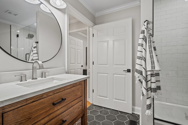 bathroom featuring tile patterned flooring, crown molding, tiled shower / bath, and vanity