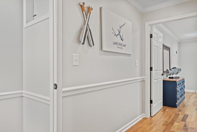 hall with crown molding and light hardwood / wood-style flooring