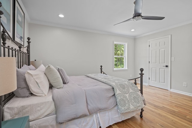 bedroom featuring light wood-type flooring, ceiling fan, and crown molding