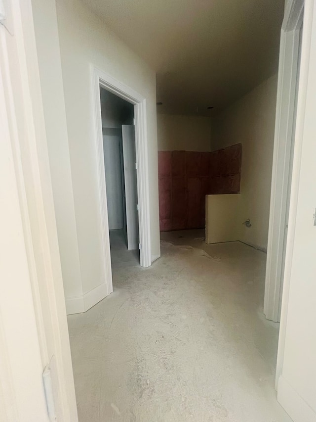 hallway with concrete floors