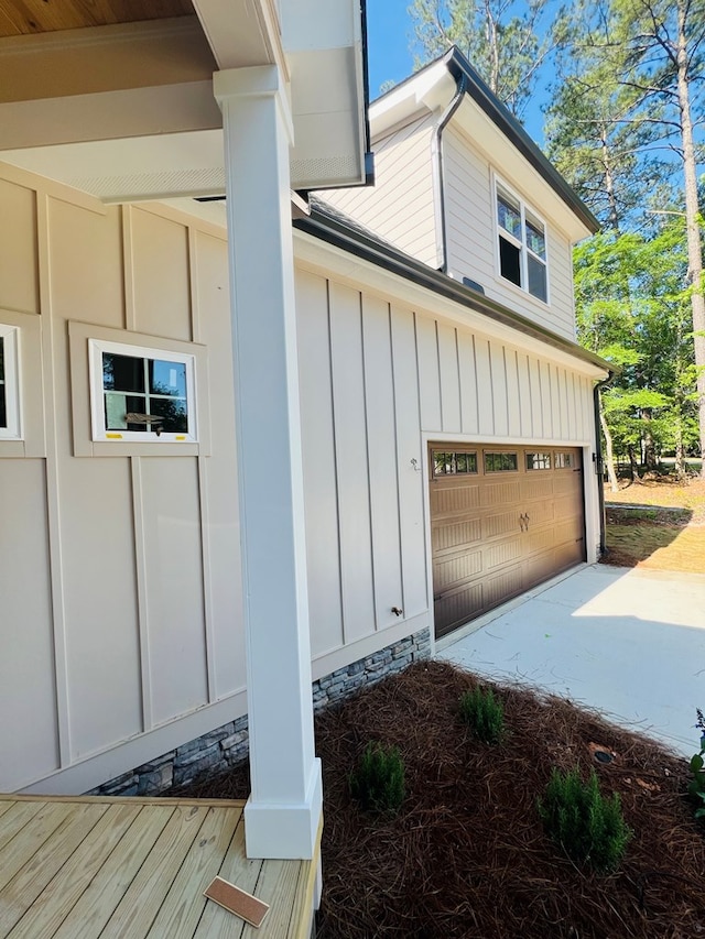 280 Greystone Dr, Milledgeville, GA 31061 - view of side of home featuring a garage, board and batten siding, and concrete driveway